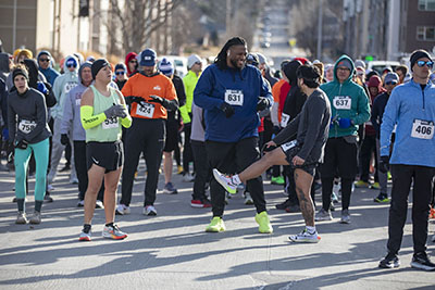 Participants gather at the starting line of the 2025 Heat the Streets Run & Walk for Warmth.