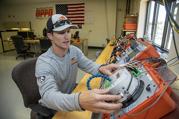 Caleb Peters tests a smart meter.