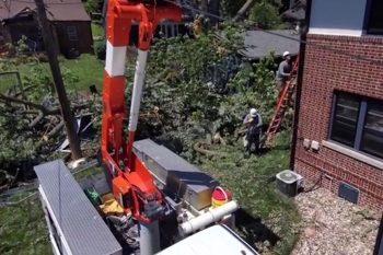 OPPD crews work to restore power in the yard of a customer after a major weather-related outage. OPPD works as quickly and safely as possible when restoring power.