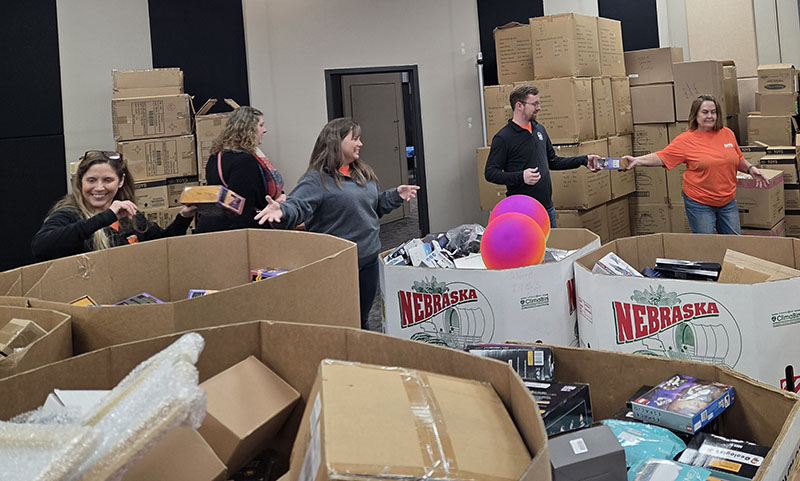 OPPD employees pass gifts down a chain at Heartland Hope Mission.