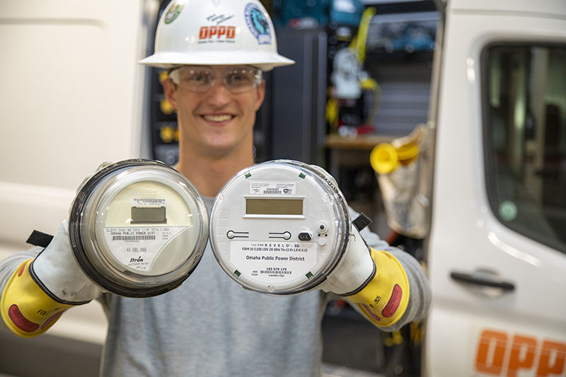 And OPPD employee holds two power meters -- one currently in use by most OPPD customers, the other a smart meter that's part of the company's AMI rollout. The meters are one of the top Wire stories of 2025.