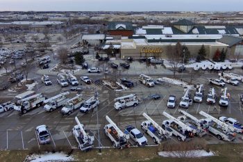 Utility trucks fill a parking lot in this aerial photo taken at Cabela's in La Vista.