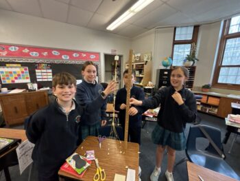 The winning Marshmallow Challenge team stands with their 33.75 inch tower.