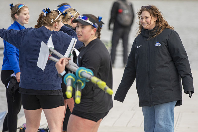 Bridget Navratil talks with rowers at practice.