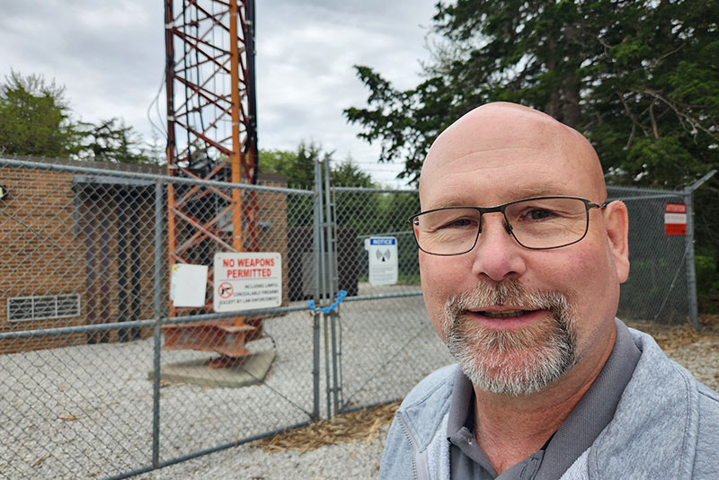 Telecommunications Team Lead Dan Weis stands near one of OPPD's radio towers.