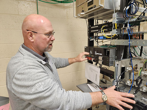 “Every day, we learn something new,” Dan Weis said, shown near equipment monitored by telecommunications engineers. “We’re developing project systems, maintaining those systems and determining what pieces and parts are necessary.” 