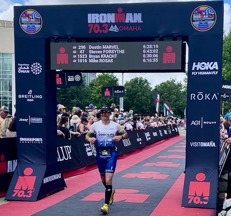Dustin Marvel runs across the finish line at the Ironman 70..3.
