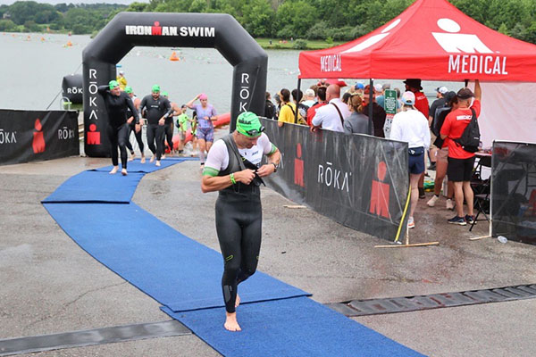 Dustin Marvel wears a wet suit after the swimming portion of the triathlon.