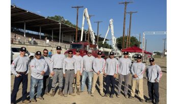 Nine competitors and three judges from OPPD gather for a photo at the Nebraska Lineworkers rodeo.