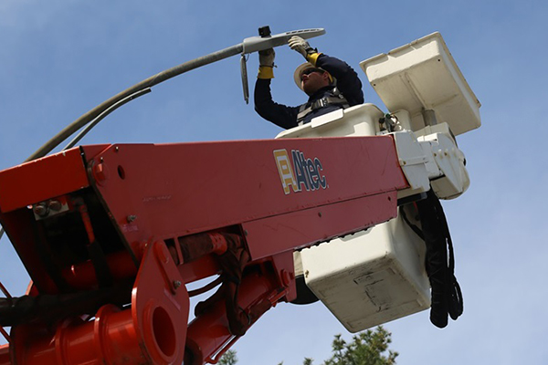 And OPPD employee puts a new LED bulb in a streetlight.