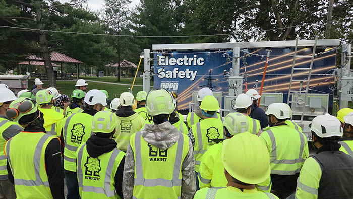Tree crew members watch as OPPD employees give a presentation on how to work safely around power lines,